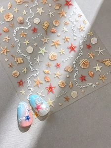 Detail of seashell and starfish nail art stickers with vibrant summer beach theme designs