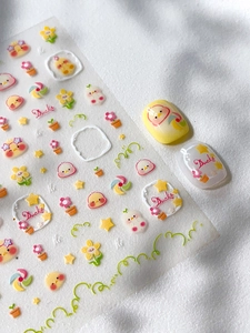 Detail of embossed yellow duck nail art stickers with cute floral and star patterns