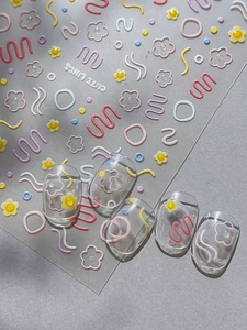 Vue macro de stickers ongles relief 3D avec motifs floraux colorés et lignes mignonnes