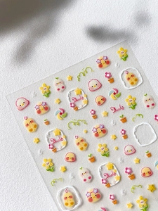 Detailed view of cute yellow duck 3D nail art stickers with floral and star patterns