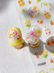 Detail of embossed yellow duck nail stickers with floral patterns and star designs