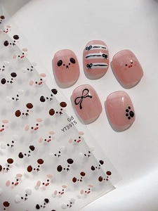 Close-up of pink jelly press-on nails with cute panda, pig, and bow tie art details