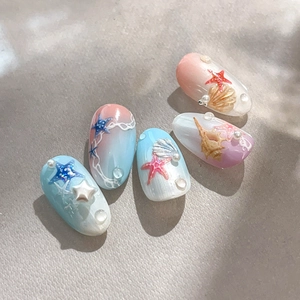 Ocean theme press-on nails with 3D starfish, shells, and gradient pink blue finish