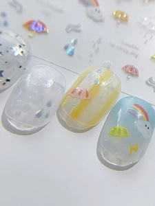 Macro detail of 3D embossed nail art stickers with rainbow and umbrella patterns