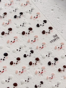 Macro detail of cute 3D jelly cartoon nail art stickers with pig and bear faces