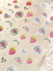 Close-up of 3D embossed strawberry and bow stickers with sweet heart patterns
