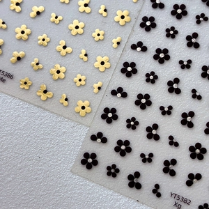 Exquisite five-petal flower nail stickers in gold and black with sparkling rhinestone detail