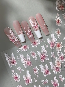 Detail of 3D embossed nail art stickers with pink floral and butterfly patterns