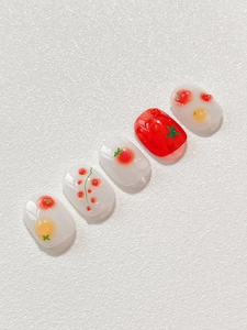 Macro shot of tomato relief nail art with 3D water drops on short round press-on nails