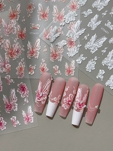 Detail of 3D embossed butterfly and flower nail stickers with elegant 3D relief texture