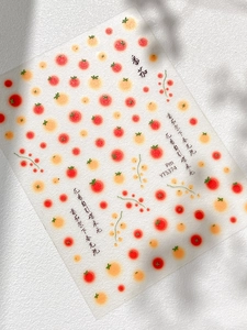 Detailed macro view of tomato nail stickers with artistic Chinese calligraphy characters