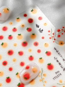 Detail of tomato pattern nail art stickers with glossy jelly texture and matte back card