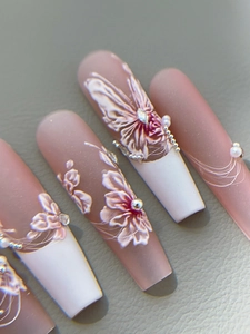 Detailed close-up of 3D embossed floral and butterfly nail art stickers on matte base