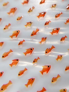 Macro view of gradient orange jelly fish nail art stickers with 3D resin texture