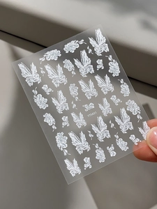 Detailed macro view of 5D embossed white butterfly and floral nail art stickers YT5431