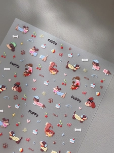 Macro detail of cute puppy and cherry nail art stickers with vibrant cartoon designs