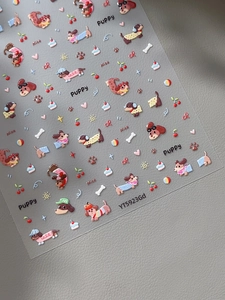 Macro detail of 3D embossed puppy nail art stickers with dog, cherry and heart motifs