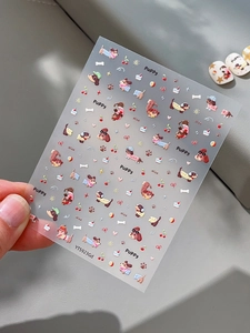 Detailed view of 5D embossed puppy nail stickers featuring cherry and cupcake designs