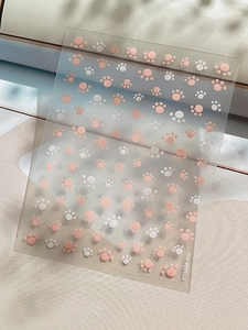 Macro shot of YT5886 cat paw nail art stickers with pink and white footprints decoration