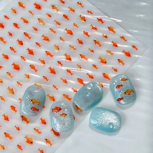 Cute orange fish nail art decals set featuring sparkling blue ocean effect manicure stickers