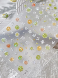 Detail of summer fruit nail stickers featuring lemon and lime slices with holographic finish