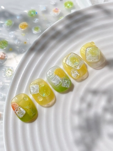 Detailed close-up of 3D lemon and lime slice nail art charms with realistic ice cubes