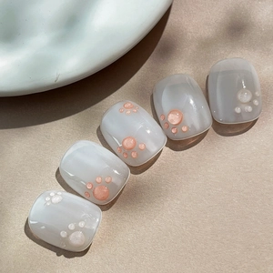 Cute 3D cat paw press-on nails with translucent grey base and glossy gel finish