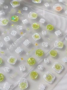 Macro view of 3D summer lemon nail art stickers with glitter and laser effects