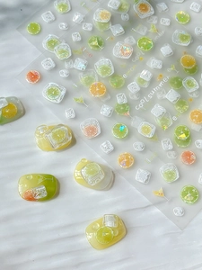 Detail showing 3D lemon and ice cube nail stickers with glossy shell finish
