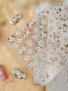 Macro detail of YT5676 floral nail stickers with gold edges on white and pink flowers