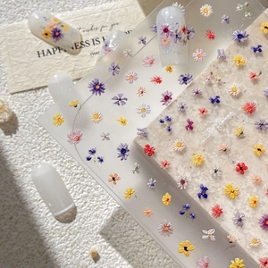 Embossed floral nail art stickers with colorful wildflower patterns on press-on nails