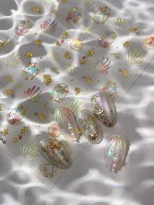Detail of 3D shell and starfish nail stickers with mermaid gradient and gold accents