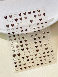 Detailed view of YT5810 heart-shaped nail art stickers with gold and brown foil accents