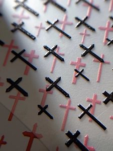 Macro detail of 3D embossed black cross nail stickers with retro artistic texture