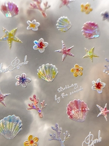 Dettaglio macro di adesivi per unghie 3D cangianti con conchiglie e stelle marine a rilievo