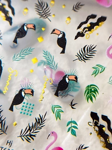 Macro detail of tropical nail art decals featuring toucans, palm leaves and summer patterns