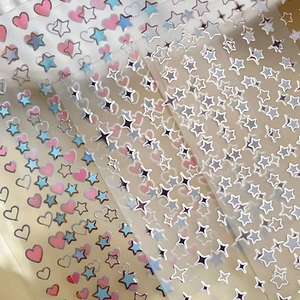 Star and heart nail art stickers in various colors with metallic gold finish for manicure