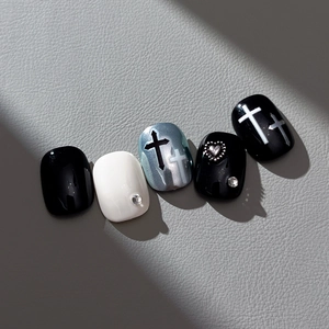 Short square press-on nails set with black crosses and silver metallic heart charms
