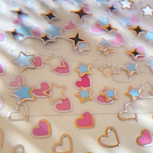 Holographic gold edge heart and star nail art stickers with pink and blue glitter finish