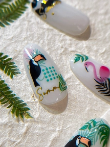 Close-up of bird nail art stickers with tropical toucan flamingo and summer leaf designs