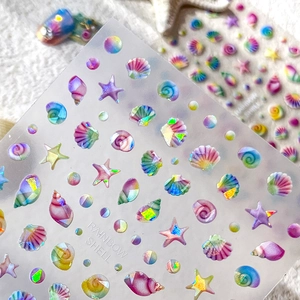 Rainbow holographic shell and starfish nail art stickers with iridescent summer ocean theme