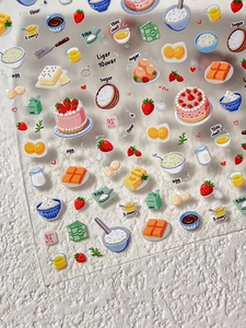 Detailed view of embossed strawberry cake nail art stickers with baking theme elements