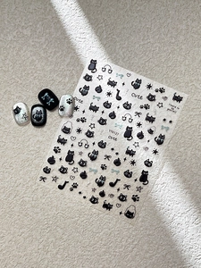 Detail of embossed black music nail art stickers featuring cute cat and note designs