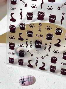 Detail of cartoon black cat and paw prints nail art stickers with fishbone patterns