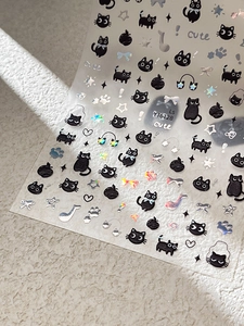 Detail of YT6128 3D cat nail stickers with holographic stars and cute motifs on white texture