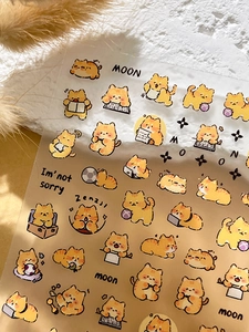 Close-up of cute 3D relief orange cat nail art stickers with various cartoon kitten poses