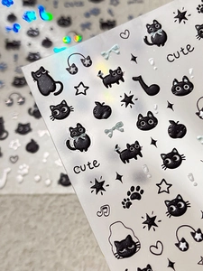Detailed macro view of 5D embossed black cat and musical note nail art stickers