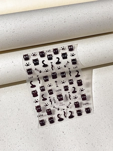 Detail view of cute cartoon black cat nail art stickers with fish bone and paw prints