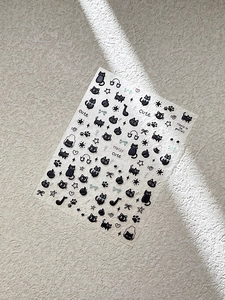 Macro view of YT6127 black cat and musical notes embossed nail art stickers on stone