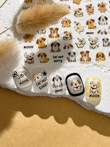Detail view of cartoon dog nail art stickers applied on nails with embossed textures